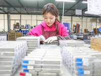 A worker is producing PTC heating block products at a micro factory in Xiashe village, Huzhou, China, on January 15, 2024. (