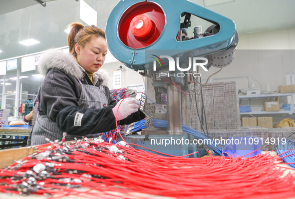 A worker is producing PTC heating block products at a micro factory in Xiashe village, Huzhou, China, on January 15, 2024. 