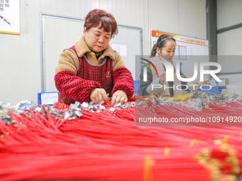 A worker is producing PTC heating block products at a micro factory in Xiashe village, Huzhou, China, on January 15, 2024. (