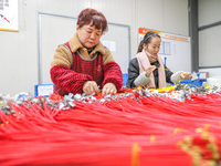 A worker is producing PTC heating block products at a micro factory in Xiashe village, Huzhou, China, on January 15, 2024. (