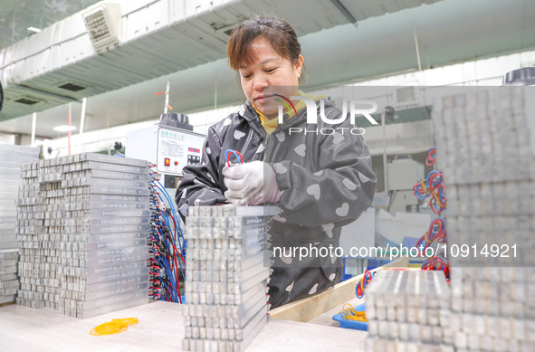 A worker is producing PTC heating block products at a micro factory in Xiashe village, Huzhou, China, on January 15, 2024. 