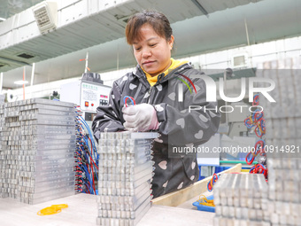 A worker is producing PTC heating block products at a micro factory in Xiashe village, Huzhou, China, on January 15, 2024. (