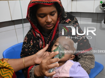 A baby is receiving treatment for pneumonia inside Dhaka Child Hospital during the winter season in Dhaka, Bangladesh, on January 15, 2024....