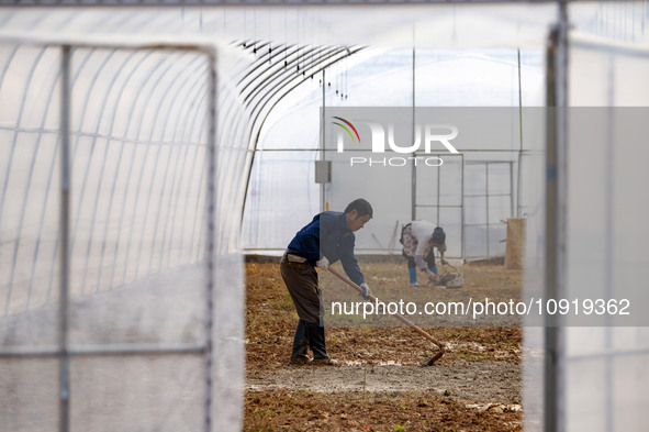 Workers are working at the construction site of a greenhouse for passion fruit cultivation in Congjiang County, Southwest China's Guizhou Pr...