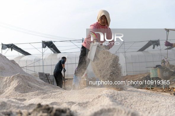 Workers are working at the construction site of a greenhouse for passion fruit cultivation in Congjiang County, Southwest China's Guizhou Pr...