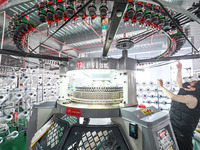 A textile worker is working on a production line at a workshop of a knitting company in Yichun, Jiangxi Province, China, on January 16, 2024...