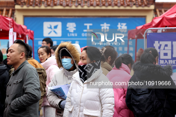 Job seekers are looking for suitable jobs at the 2024 job fair in Zaozhuang, East China's Shandong province, on January 17, 2024. 