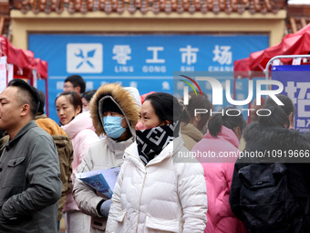 Job seekers are looking for suitable jobs at the 2024 job fair in Zaozhuang, East China's Shandong province, on January 17, 2024. (