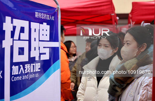 Job seekers are checking job postings at the 2024 job fair in Zaozhuang, East China's Shandong province, on January 17, 2024. 