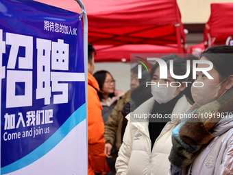 Job seekers are checking job postings at the 2024 job fair in Zaozhuang, East China's Shandong province, on January 17, 2024. (