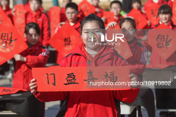 Pupils are showing off the Chinese character ''Fu'' in a Spring Festival couplet at Shangbai Primary School in Deqing County, Huzhou City, Z...