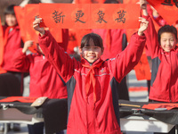 Pupils are showing off the Chinese character ''Fu'' in a Spring Festival couplet at Shangbai Primary School in Deqing County, Huzhou City, Z...