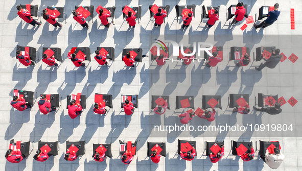 Teachers and students are writing the Chinese New Year couplet ''Fu'' at Shangbai Primary School in Deqing County, Huzhou, China, on January...