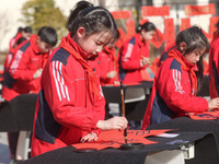 A primary school student is writing a Chinese Spring Festival couplet ''Fu'' at Shangbai Primary School in Deqing County, Huzhou, China, on...