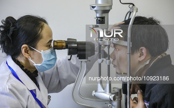 A medical worker is checking the eyes of a young applicant in Huai'an, China, on January 19, 2024. 