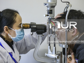 A medical worker is checking the eyes of a young applicant in Huai'an, China, on January 19, 2024. (