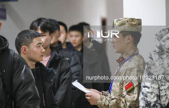 A cadre is checking the information of young applicants in Huai'an, China, on January 19, 2024. 