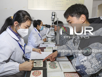 A medical worker is checking the eyesight of a young applicant in Huai'an, Jiangsu Province, China, on January 19, 2024. (