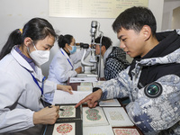 A medical worker is checking the eyesight of a young applicant in Huai'an, Jiangsu Province, China, on January 19, 2024. (