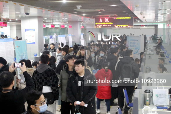 Job seekers are looking for positions at a job fair for 2024 college graduates in Suzhou, Jiangsu Province, China, on January 19, 2024. 