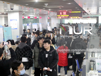 Job seekers are looking for positions at a job fair for 2024 college graduates in Suzhou, Jiangsu Province, China, on January 19, 2024. (