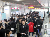 Job seekers are looking for positions at a job fair for 2024 college graduates in Suzhou, Jiangsu Province, China, on January 19, 2024. (