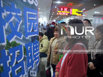 Job seekers are looking for positions at a job fair for 2024 college graduates in Suzhou, Jiangsu Province, China, on January 19, 2024. (