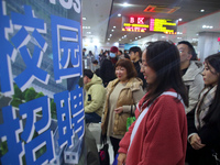 Job seekers are looking for positions at a job fair for 2024 college graduates in Suzhou, Jiangsu Province, China, on January 19, 2024. (