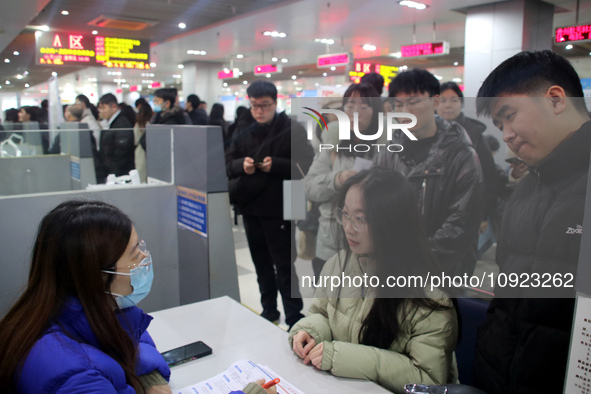 Job seekers are looking for positions at a job fair for 2024 college graduates in Suzhou, Jiangsu Province, China, on January 19, 2024. 