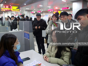 Job seekers are looking for positions at a job fair for 2024 college graduates in Suzhou, Jiangsu Province, China, on January 19, 2024. (