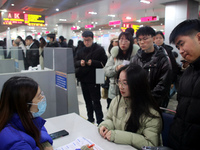 Job seekers are looking for positions at a job fair for 2024 college graduates in Suzhou, Jiangsu Province, China, on January 19, 2024. (