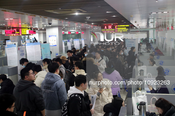 Job seekers are looking for positions at a job fair for 2024 college graduates in Suzhou, Jiangsu Province, China, on January 19, 2024. 