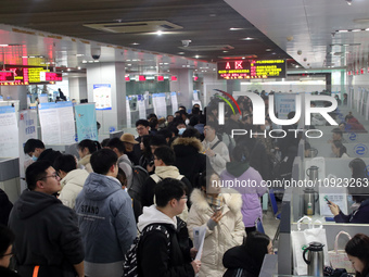 Job seekers are looking for positions at a job fair for 2024 college graduates in Suzhou, Jiangsu Province, China, on January 19, 2024. (