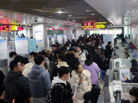 Job seekers are looking for positions at a job fair for 2024 college graduates in Suzhou, Jiangsu Province, China, on January 19, 2024. (