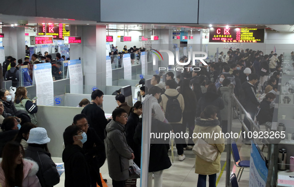 Job seekers are looking for positions at a job fair for 2024 college graduates in Suzhou, Jiangsu Province, China, on January 19, 2024. 