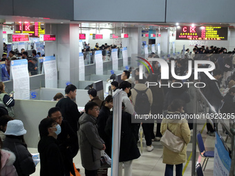 Job seekers are looking for positions at a job fair for 2024 college graduates in Suzhou, Jiangsu Province, China, on January 19, 2024. (