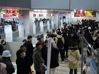 Job seekers are looking for positions at a job fair for 2024 college graduates in Suzhou, Jiangsu Province, China, on January 19, 2024. (