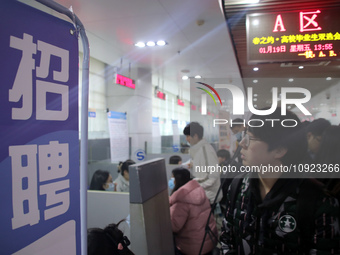 Job seekers are looking for positions at a job fair for 2024 college graduates in Suzhou, Jiangsu Province, China, on January 19, 2024. (