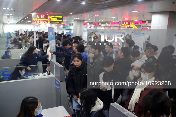 Job seekers are looking for positions at a job fair for 2024 college graduates in Suzhou, Jiangsu Province, China, on January 19, 2024. 