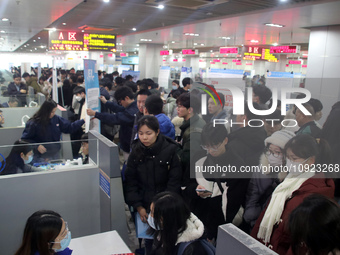 Job seekers are looking for positions at a job fair for 2024 college graduates in Suzhou, Jiangsu Province, China, on January 19, 2024. (