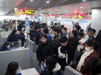 Job seekers are looking for positions at a job fair for 2024 college graduates in Suzhou, Jiangsu Province, China, on January 19, 2024. (