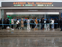 Job seekers are looking for positions at a job fair for 2024 college graduates in Suzhou, Jiangsu Province, China, on January 19, 2024. (