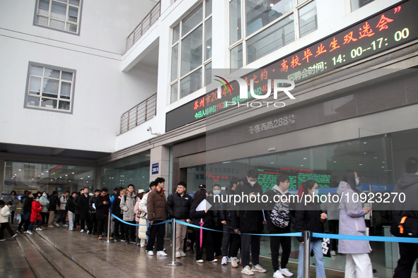 Job seekers are looking for positions at a job fair for 2024 college graduates in Suzhou, Jiangsu Province, China, on January 19, 2024. 