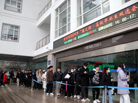 Job seekers are looking for positions at a job fair for 2024 college graduates in Suzhou, Jiangsu Province, China, on January 19, 2024. (