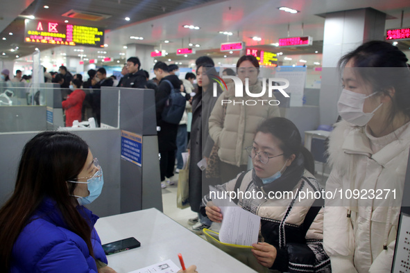 Job seekers are looking for positions at a job fair for 2024 college graduates in Suzhou, Jiangsu Province, China, on January 19, 2024. 