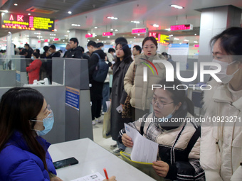 Job seekers are looking for positions at a job fair for 2024 college graduates in Suzhou, Jiangsu Province, China, on January 19, 2024. (