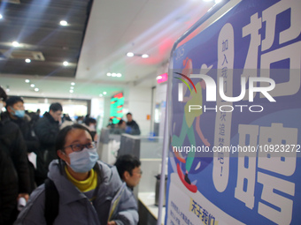 Job seekers are looking for positions at a job fair for 2024 college graduates in Suzhou, Jiangsu Province, China, on January 19, 2024. (