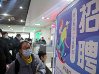 Job seekers are looking for positions at a job fair for 2024 college graduates in Suzhou, Jiangsu Province, China, on January 19, 2024. (