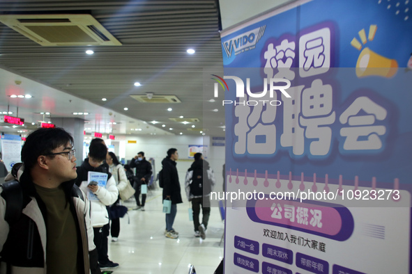 Job seekers are looking for positions at a job fair for 2024 college graduates in Suzhou, Jiangsu Province, China, on January 19, 2024. 