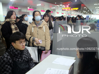 Job seekers are looking for positions at a job fair for 2024 college graduates in Suzhou, Jiangsu Province, China, on January 19, 2024. (